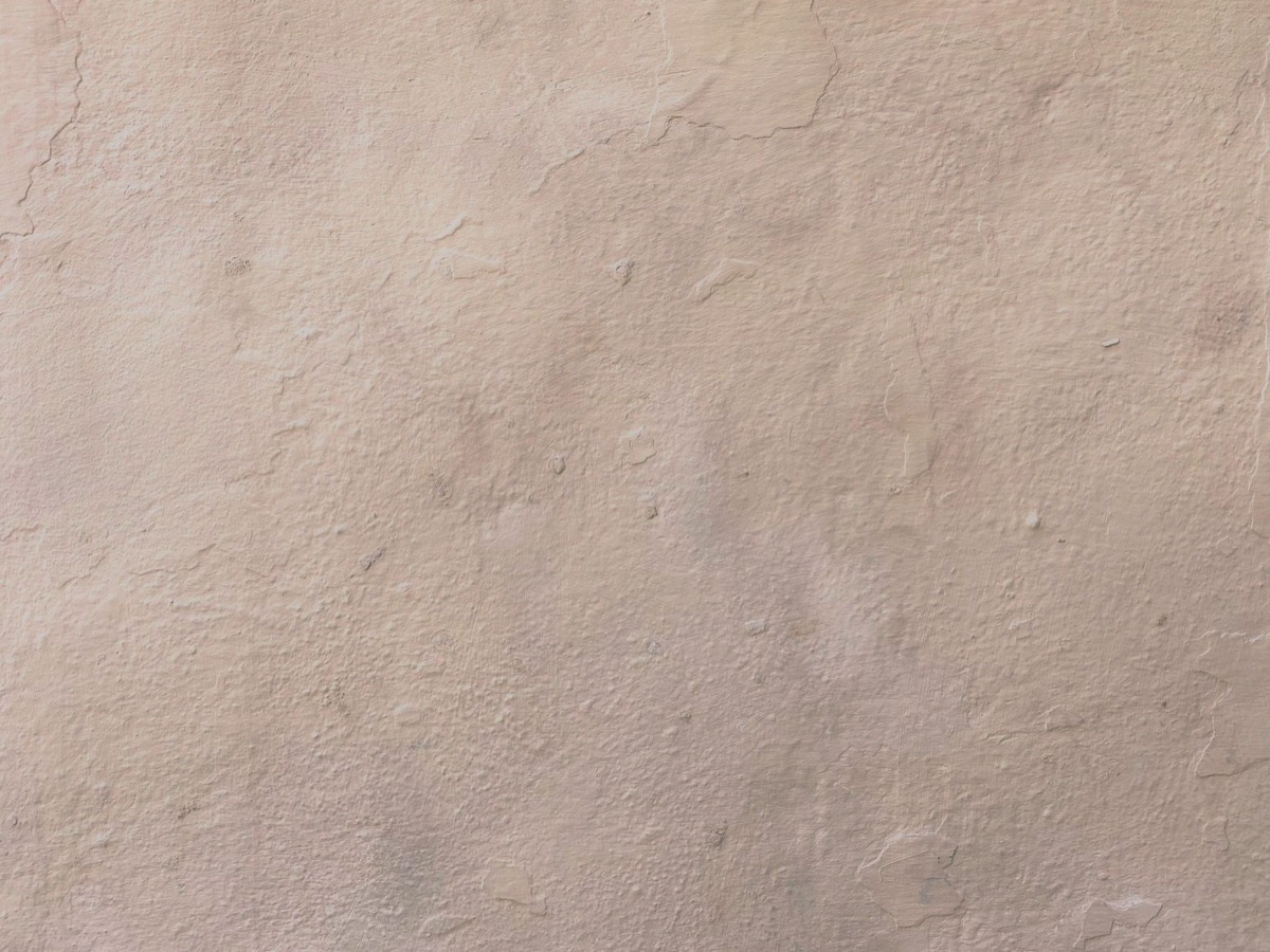 Close-up of a hairline crack running across a white painted drywall surface, showing subtle damage